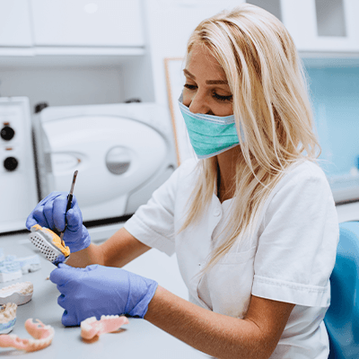 A lab technician making dentures