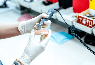 A technician working on a partial denture