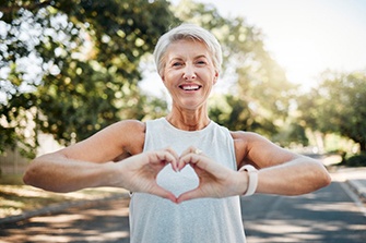 Lady makes shape of heart with her hands