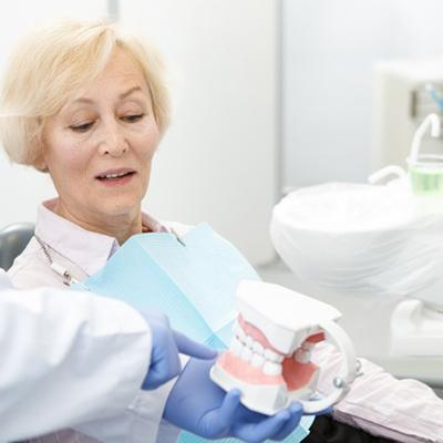 Dentist consulting with patient about implant dentures