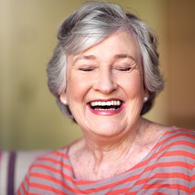 Woman smiling brightly in her home