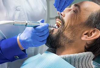 a man having his teeth cleaned at the dental office