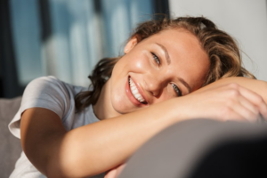 Woman smiling comfortably from her couch